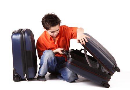 Little boy with suitcase on white backgroundの写真素材