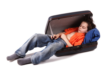 Little boy with suitcase on white backgroundの写真素材