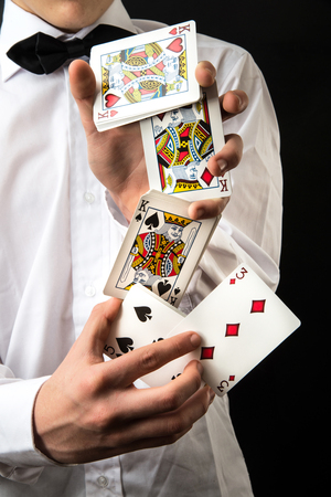 Young magician with playing cards