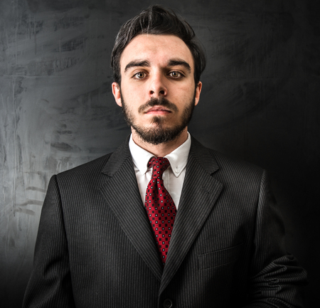 young businessman on dark backgroundの写真素材