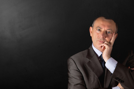 isolated businessman on dark background