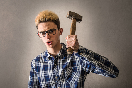 Aggressive boy threatening with a hammerの写真素材