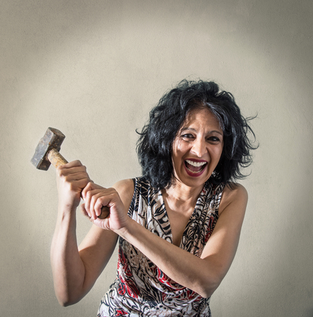 a Woman screaming with in hand a hammer a Woman screaming with in hand a hammer