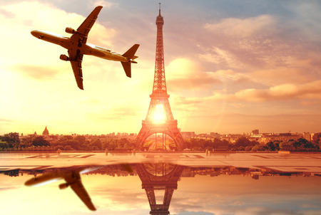 landscape of the Eiffel Tower in Paris at sunset with airplaneの写真素材