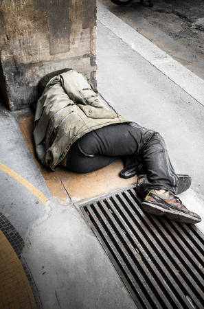 a Beggar sleeping on the groundの写真素材