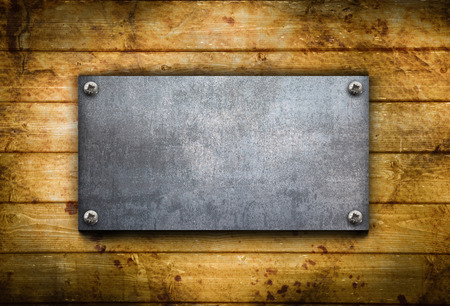 an industrial metal plate on a wooden backgroundの写真素材