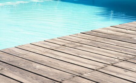 a detailed view of a wooden floor and poolの写真素材