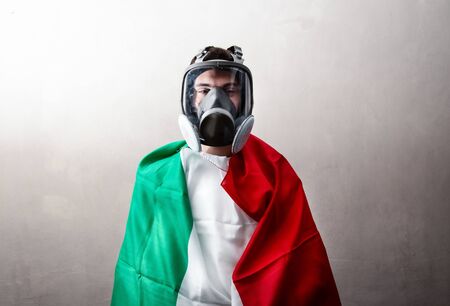 a person wrapped in an Italian flag with antibacterial maskの写真素材