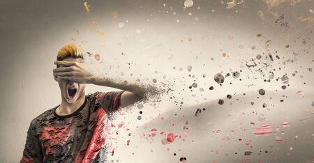 Desperate boy with hand in front of eyes dissolveの写真素材