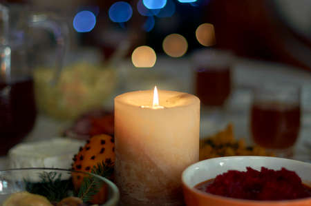 a candle burning on the set tableの写真素材