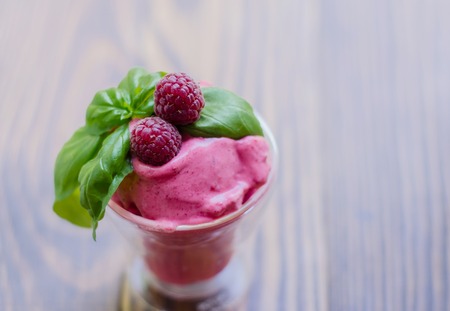 Raspberry Ice Cream, summer sundae with fresh fruits on rustic background.の写真素材