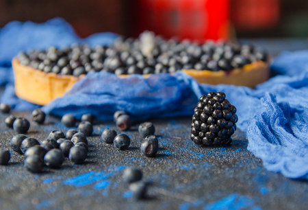 Fresh ripe bilberries and blueberries on a blue background. Close upの写真素材