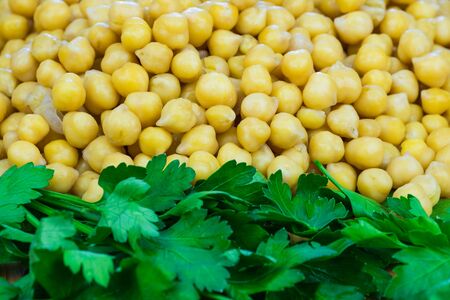 Parsley and chickpeas close-up. Texture of cooked chickpeas and fresh parsleyの写真素材
