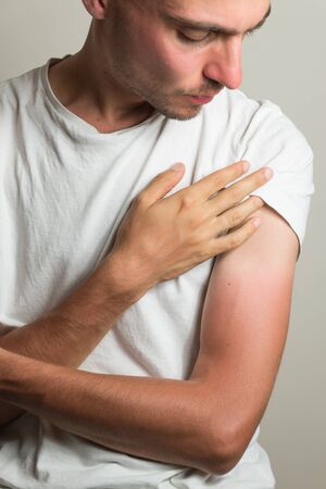 discontent man examines farmer's tan on his hands