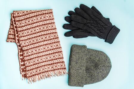 Top view of winter clothing accessories for outdoor use. Knit-hat beanie, winter gloves and wool...