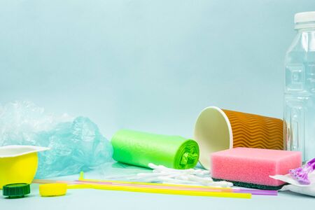 Plastic waste concept: varitety of single use objects that get thrown out every day. Plastic bottle,...