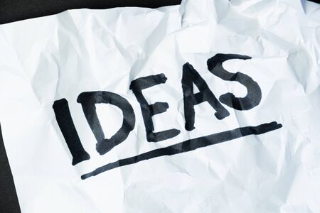 Word "ideas" handwritten on crumpled paper. Sign, concept of failed plans or poor management, abstract illustrative imageの写真素材