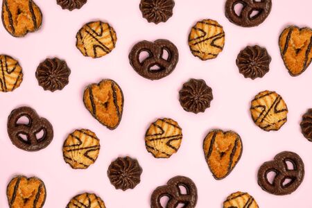 Pattern of cookies in pink background. Consuming and enjoying sweets, treats or carbsの写真素材