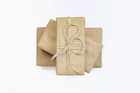 Presents in wrapped in recycled paper, top view. Holiday gifts wrapped in sustainable natural...