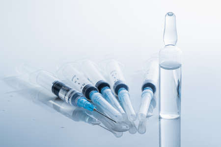 Syringes in clean medical background. Concept of injection drugs, medicine, vaccination or...