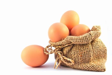 Brown eggs in canvas sack isolated on a white background の写真素材