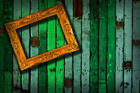 picture frame on vintage green painted wooden wall の写真素材