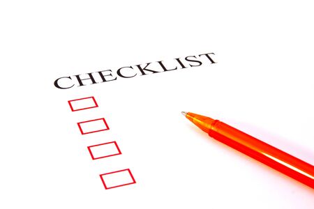Checklist with pen and checked boxes. 