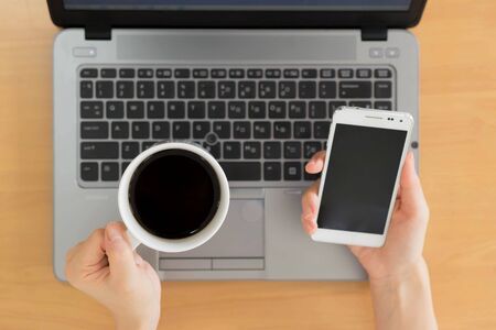 Businesswoman Working Using Laptop and mobile phoneの写真素材