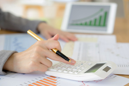 picture of woman hand with calculator and papers