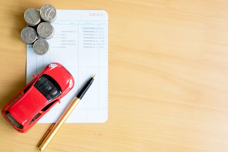 Coins stack in columns, saving book, car. Finance and banking concept.の写真素材