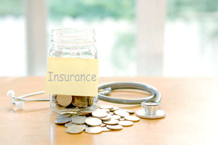 Education budget concept. stethoscopes money savings in a glassの写真素材