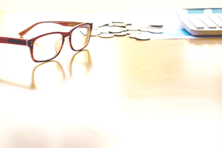 Glasses coin calculator on tableの写真素材