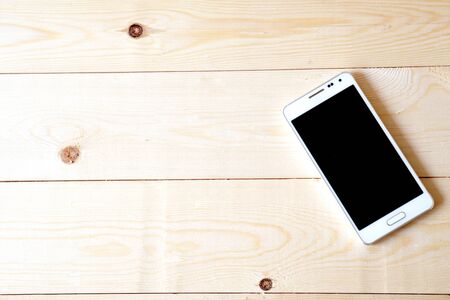 Phone on wood tableの写真素材