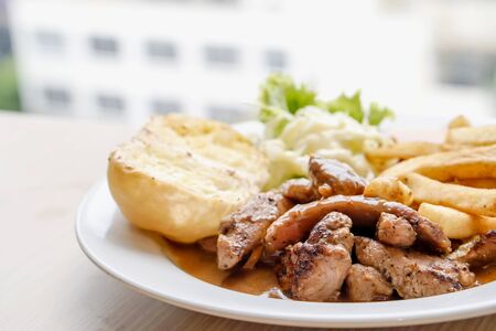 Pepper pork steak with French fried and saladの写真素材