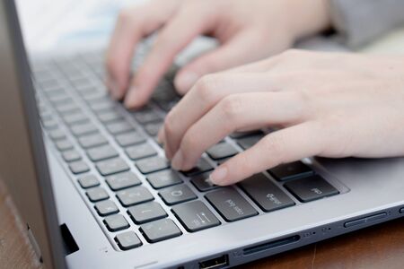 Woman Typing On Laptop Keyboard,Close-up