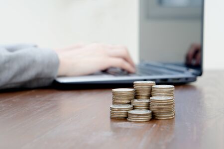 Stack Of Increasing Coins On Office Desk