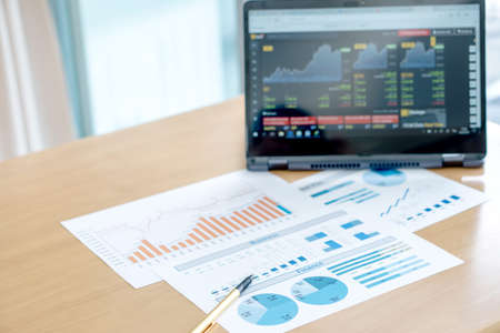 Business workplace with laptop, graph, penの写真素材