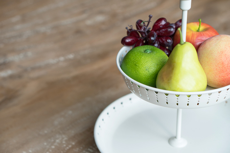Fruit in white wire basketの写真素材