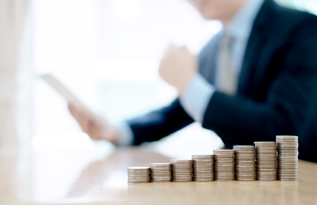 Businessman With Digital Tablet And Coinの写真素材