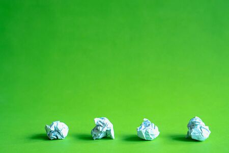 Trash ball paper crumpled isolated on green background idea business conceptの写真素材