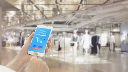 Woman using cellphone while shopping