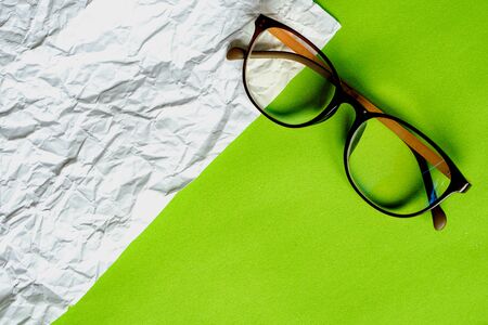 White crumpled paper and green paper. eyeglass concept.の写真素材