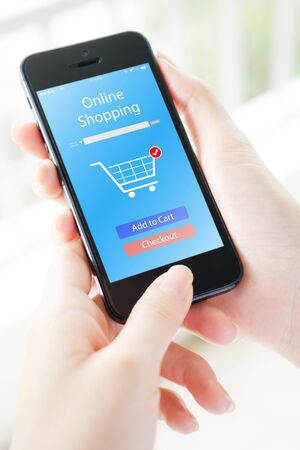 Woman holding phone with app online on the screenの写真素材