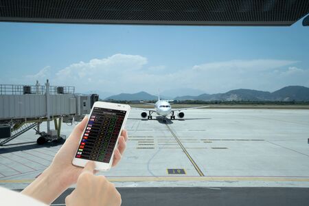 Hands holding mobile with currency exchange ratesの写真素材