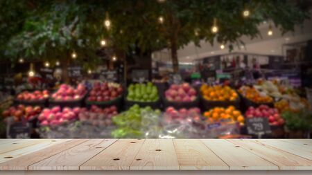 Empty wood table top with fruit market blurred backgroundの写真素材