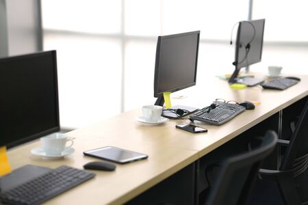 Side view of chairs computers and headset in a modern office or training centerの写真素材