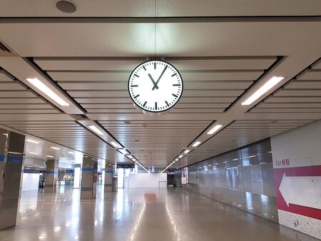 Public clock in railway station, no people background