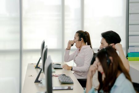 Relaxed businesswoman wearing headset in the office.