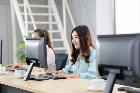 Young employee call center talking with the clientの写真素材