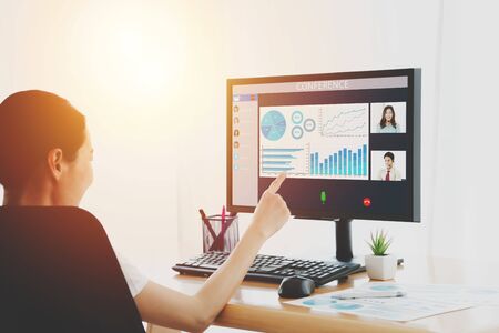 Business woman talking to her colleagues about plan in video conference.の写真素材